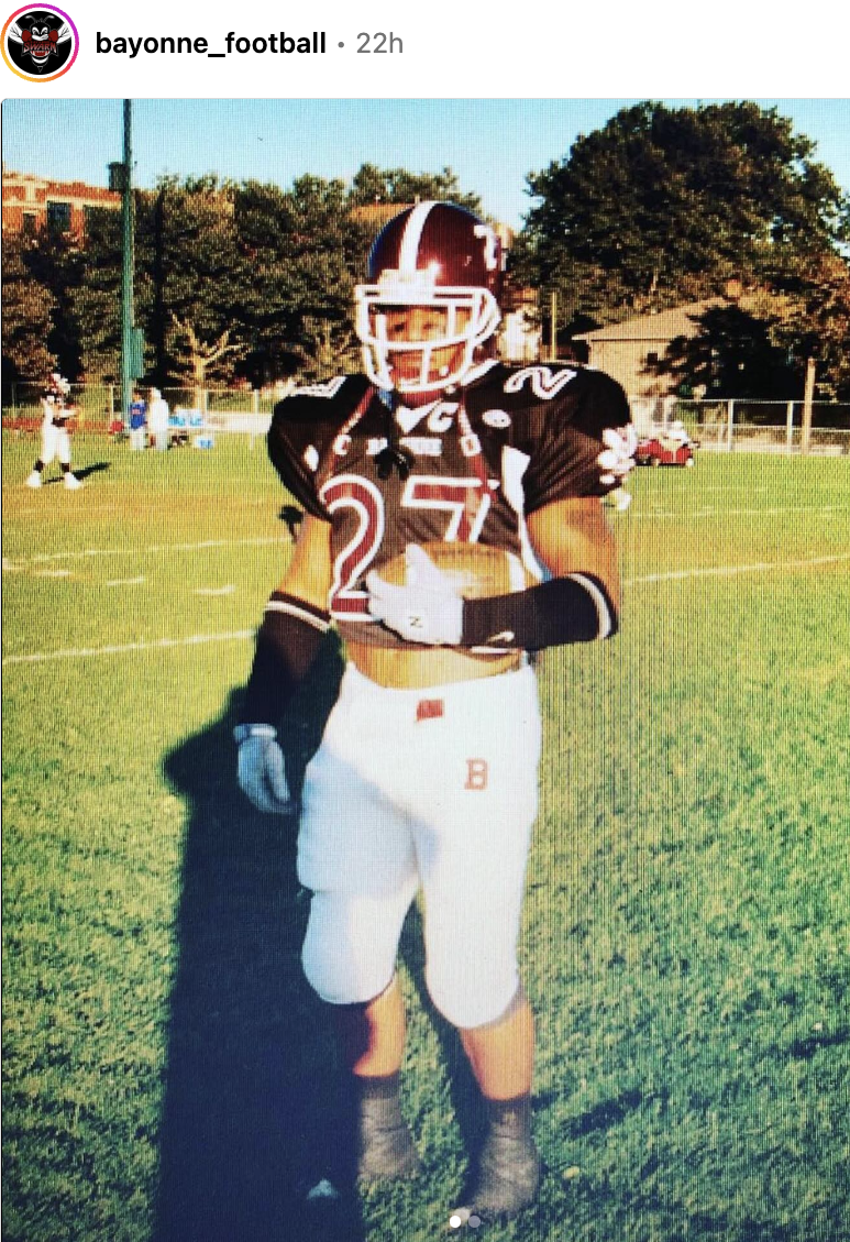  Jerome Hayes stands in football uniform.